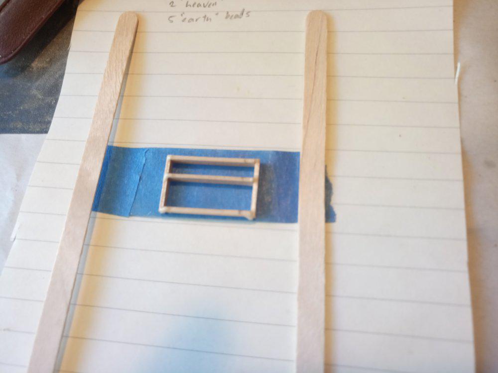 Wood frame on blue tape as glue dries